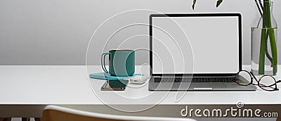Laptop with clipping path on white desk with smartphone, accessories, supplies and copy space Stock Photo