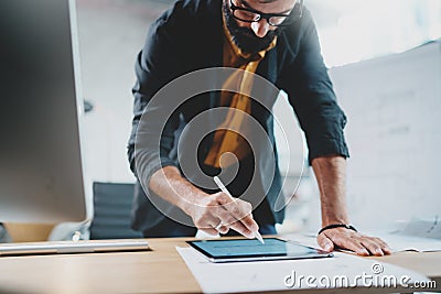Close up view of man in formal wear working with portable tablet computer and drawings digital plans in modern lightful Stock Photo