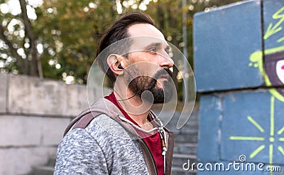 Close up view of man wearing headphones running. Stock Photo