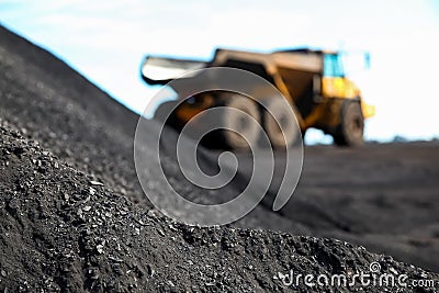 Close up view of Manganese ore with Mining Dump Truck in the background Stock Photo