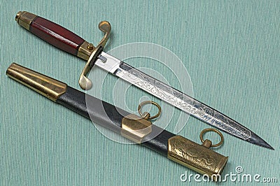 Close up view of military sea dirk isolated on blue-green background. Marine sea fleet. Stock Photo