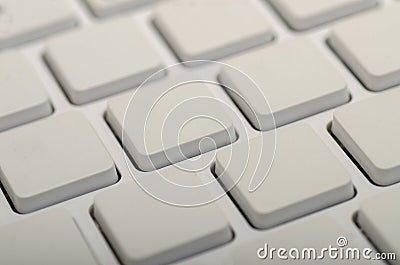 A close-up view of a minimalist white keyboard showcasing its clean, square keycaps in a grid pattern Stock Photo