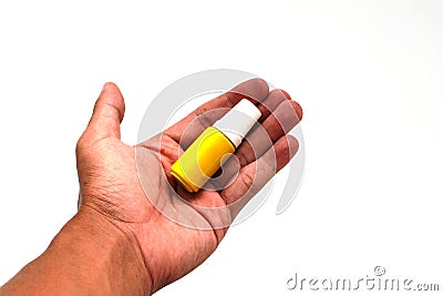 5 ml yellow bottle with a white cap and blank spaces on hand isolated on white background Stock Photo