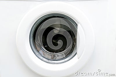 Close-up view of modern white washing machine round front door,interface. Interior view of laundry cabinet.Laundry Stock Photo