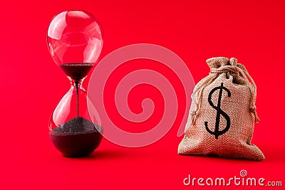 Close-up view of moneybag account market management stocks shares rate running out of time sand clock counting isolated Stock Photo