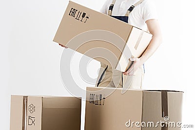 Close-up view of mover holding cardboard box isolated on white background. Concept o relocation into new house. Loader with boxes. Stock Photo