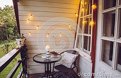 Close up view of nautical theme home balcony at night with string light bulbs. Stock Photo