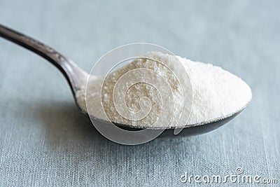 Dry Nonfat Milk on a Vintage Spoon Stock Photo