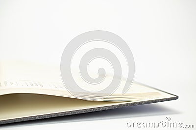 Close-up view of opened calendar diary pages with dates on white background with free space and selective focus Stock Photo