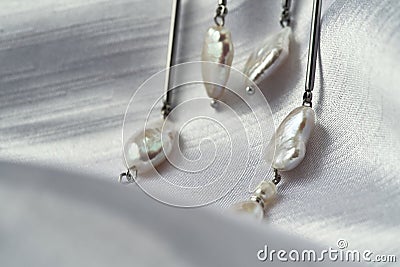 Close up view of pearls on dangle earrings Stock Photo