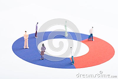 Close up view of plastic people figures on red and blue diagram isolated on white Stock Photo