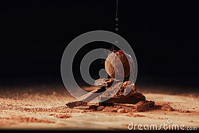 Close up view of pouring caramel onto heap made of truffle and chocolate bars Stock Photo