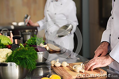 Close-up view of professional team of cooks preparing ingredients Stock Photo