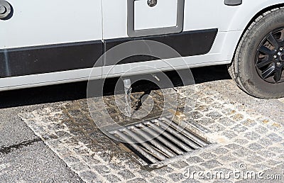 Close up view of proper disposal of gray water and waste water from a camper van at an RV park Editorial Stock Photo