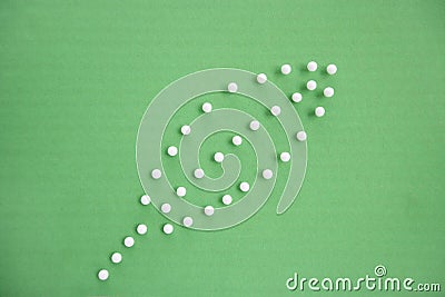 Close-up view of push pins forming leaf over colored background Stock Photo