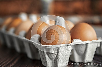 Close-up view of raw chicken eggs on wooden background. Fresh farm egg. Stock Photo