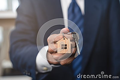 Close up view realtor broker holding home keychain in his hand Stock Photo