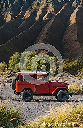Close up view of red jeep with Bromo volcano background Stock Photo