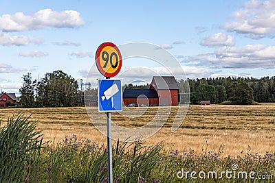 Close up view of road signs on yellow field and blue sky with white couds backgrounds. Stock Photo