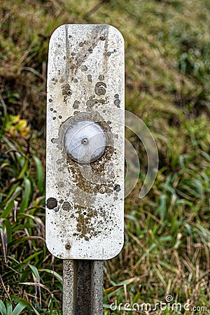 A close up view of a roadside reflector on a post Stock Photo