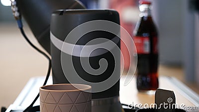 Close-up view of robot hand taking the coca-cola bottle at the robotics forum exhibition. Media. Robots and innovative Editorial Stock Photo