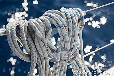 Close-up view of sailboat ropes at sunny weather, pulleys and ropes on the mast, Yachting sport, ship equipment, sea is Stock Photo