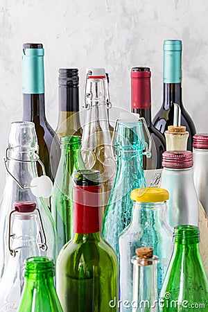 A close up view of a selection of colourful empty bottles against a bright background and lit from the left. Stock Photo