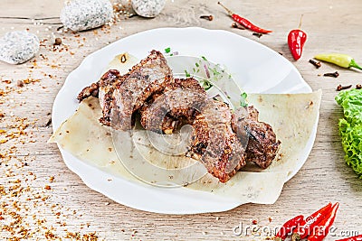 Close up view on served cooked on the grill lamb. shashlik or barbecue meat on pita. Shish kebab, traditional georgian cuisine Stock Photo