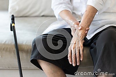 Close up view on the shaking hand of the senior woman,symptom of resting tremor or parkinson`s disease,old elderly patient holdin Stock Photo