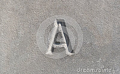 Close-up view of a single one letter A carved into a smooth gray stone. Latin alphabet letters, written language history, culture Stock Photo