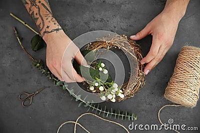 Close up view of tattooed florist preparing flower Stock Photo