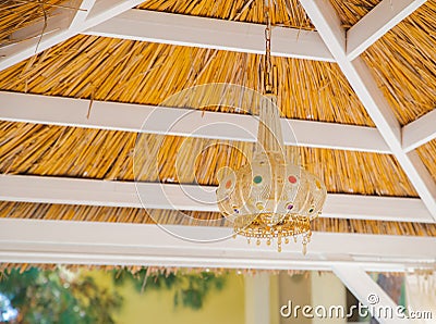 Close up view of a traditional bamboo lampshade hanging on the roof of the garden gazebo Stock Photo