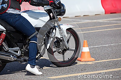 Close up view at training motorbike with person practicing on motor-vehicle proving ground Stock Photo