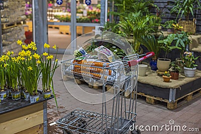 Close up view of trolley in store with purchased garden supplies for planting plant. Sweden. Editorial Stock Photo