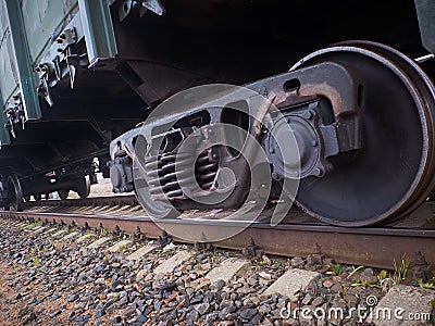 Close up view on used rusted railway freight car bogie with wheel sets with axleboxes, coil springs. Freight train on the railway Stock Photo