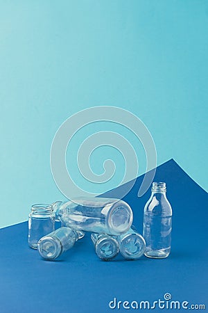 close up view of various glass bottles and jars on blue background, recycle concept Stock Photo