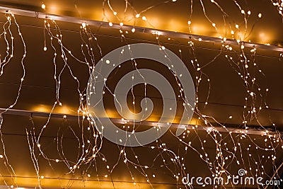 Close-up view of warm glowing string lights creating a festive atmosphere Stock Photo
