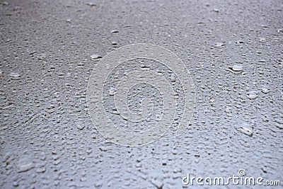 Close-up view on water drops on window in rain. Drops of rain on the glass concept photo. Front view photography with blurred Stock Photo