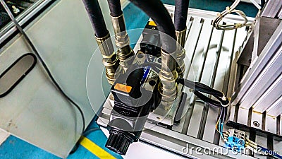 Close up view of 4/3 ways Solenoid Operated Directional Valves connected to hydraulic circuit. Editorial Stock Photo