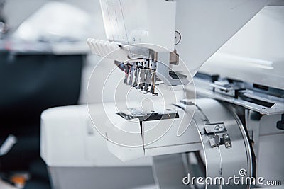 Close up view of white automatic sewing machine at factory Stock Photo