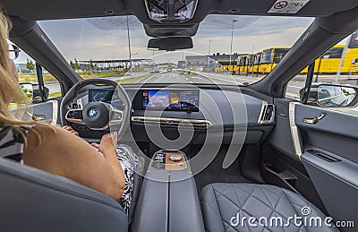 Close-up view of woman driving new electric car BMW IX 40. Editorial Stock Photo