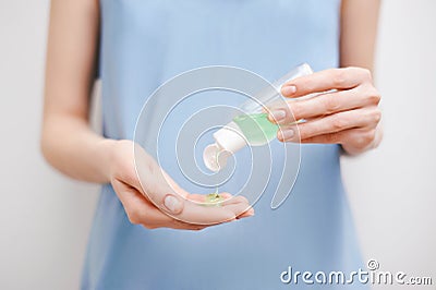 Close up view of woman`s hands using a personal antiseptic or sanitizer. Covid-19 protection measures Stock Photo