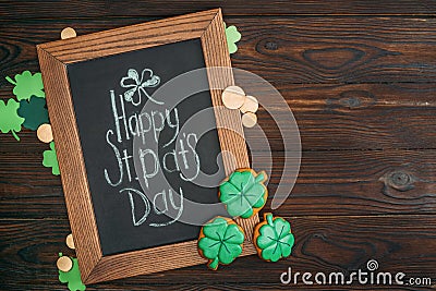 close-up view of wooden frame with happy st patricks day inscription and golden coins Stock Photo