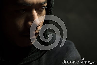 Young man of Asian wear black sweater with hood Stock Photo