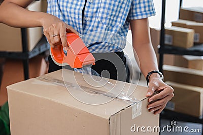 Taping carton boxes to be shipped Stock Photo