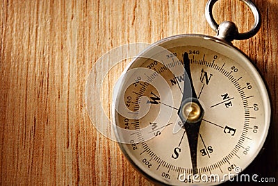 Close up Vintage Compass Lying on Wooden Table Stock Photo