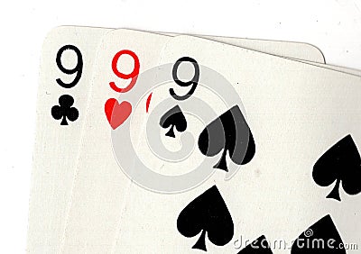 Close up of vintage playing cards showing three nines. Stock Photo