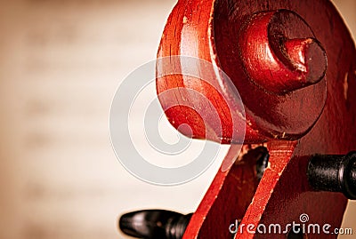 Close Up of Violin Scroll in front of Sheet Music Stock Photo