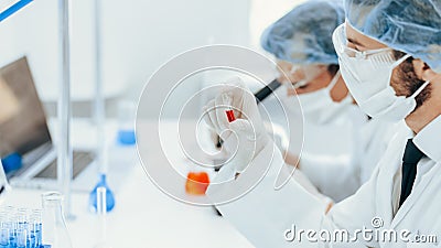 Close up. virologist holds an ampoule with a new vaccine. Stock Photo