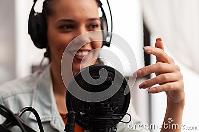 Close up of vlogger speaking at podcast microphone gesturing during life video vlog. Stock Photo